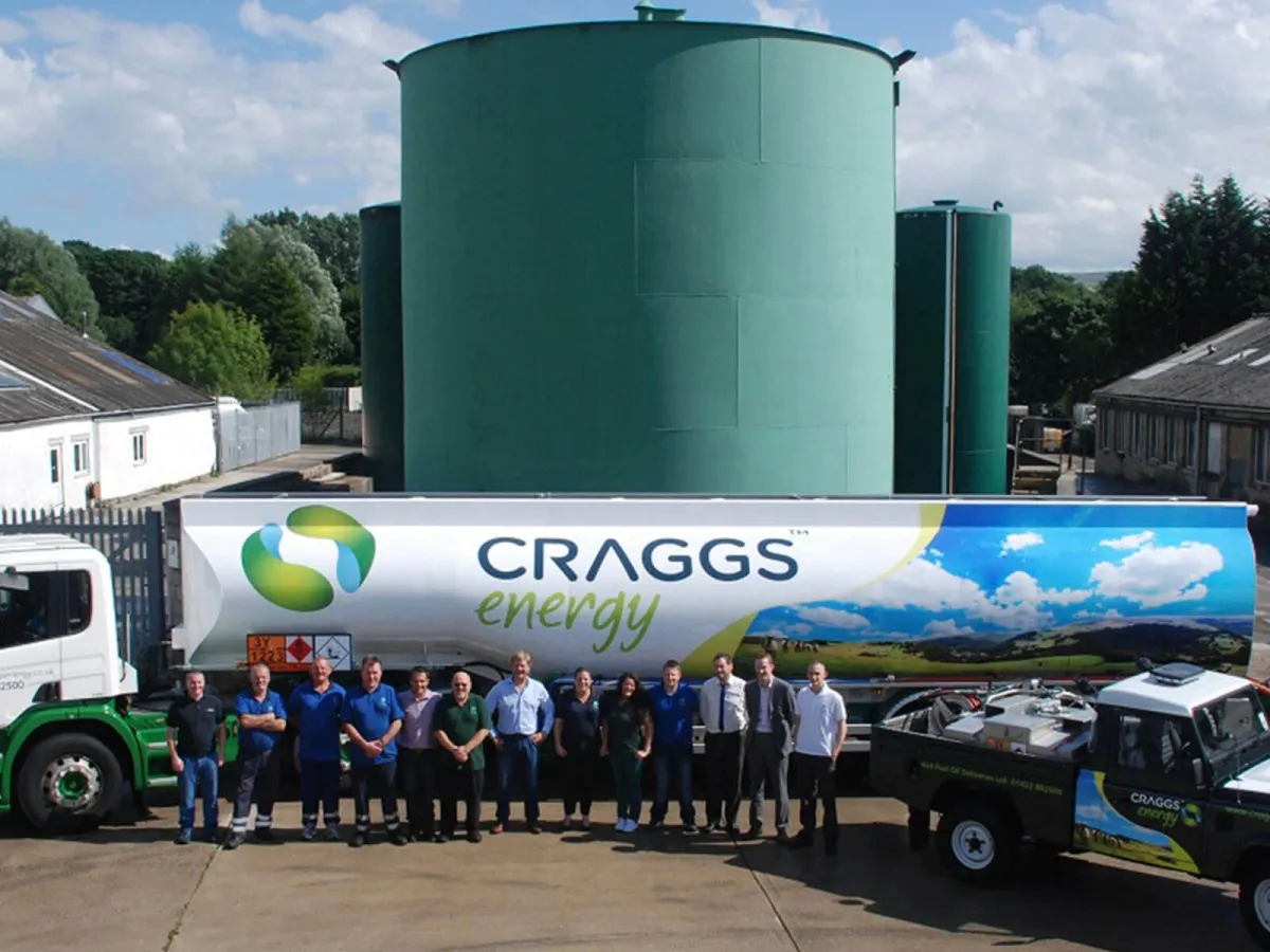 The Craggs Energy team in front of a fuel tanker and storage tanks